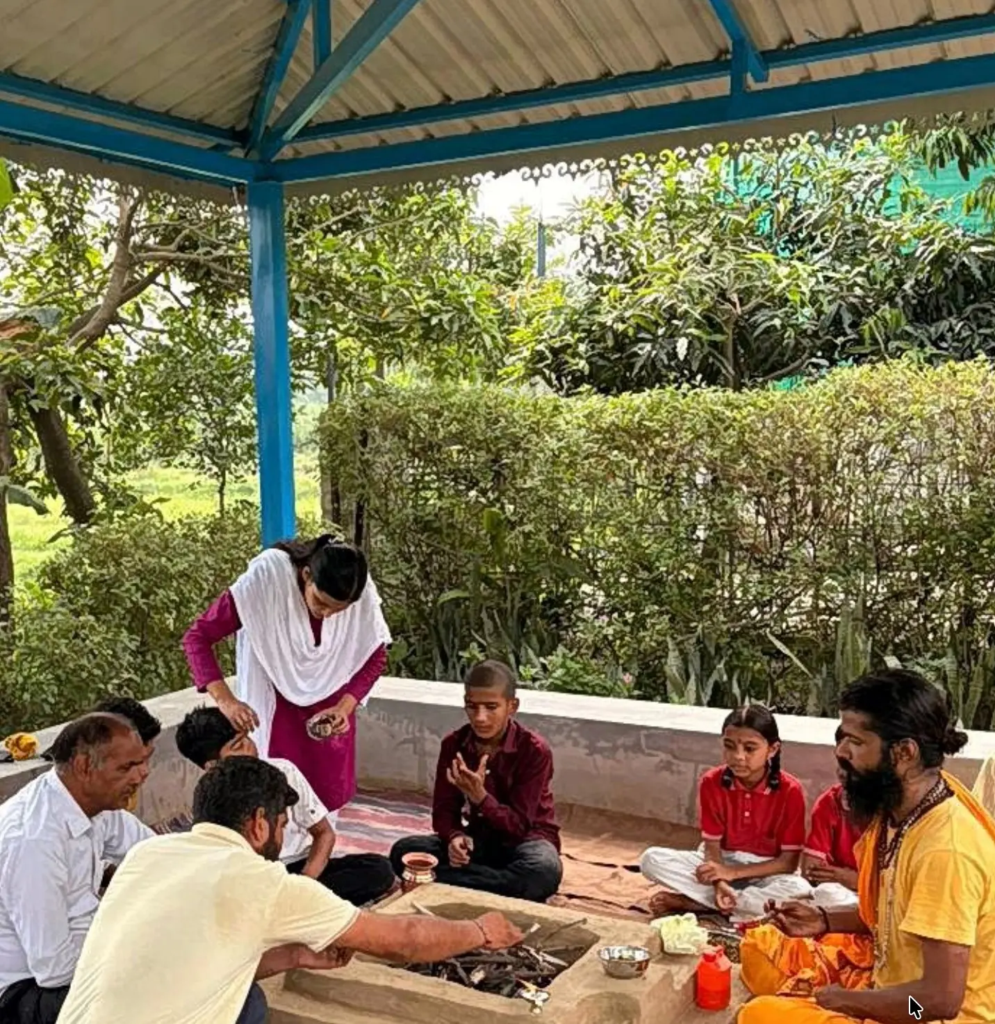 Students and staff gathered around the sacred fire