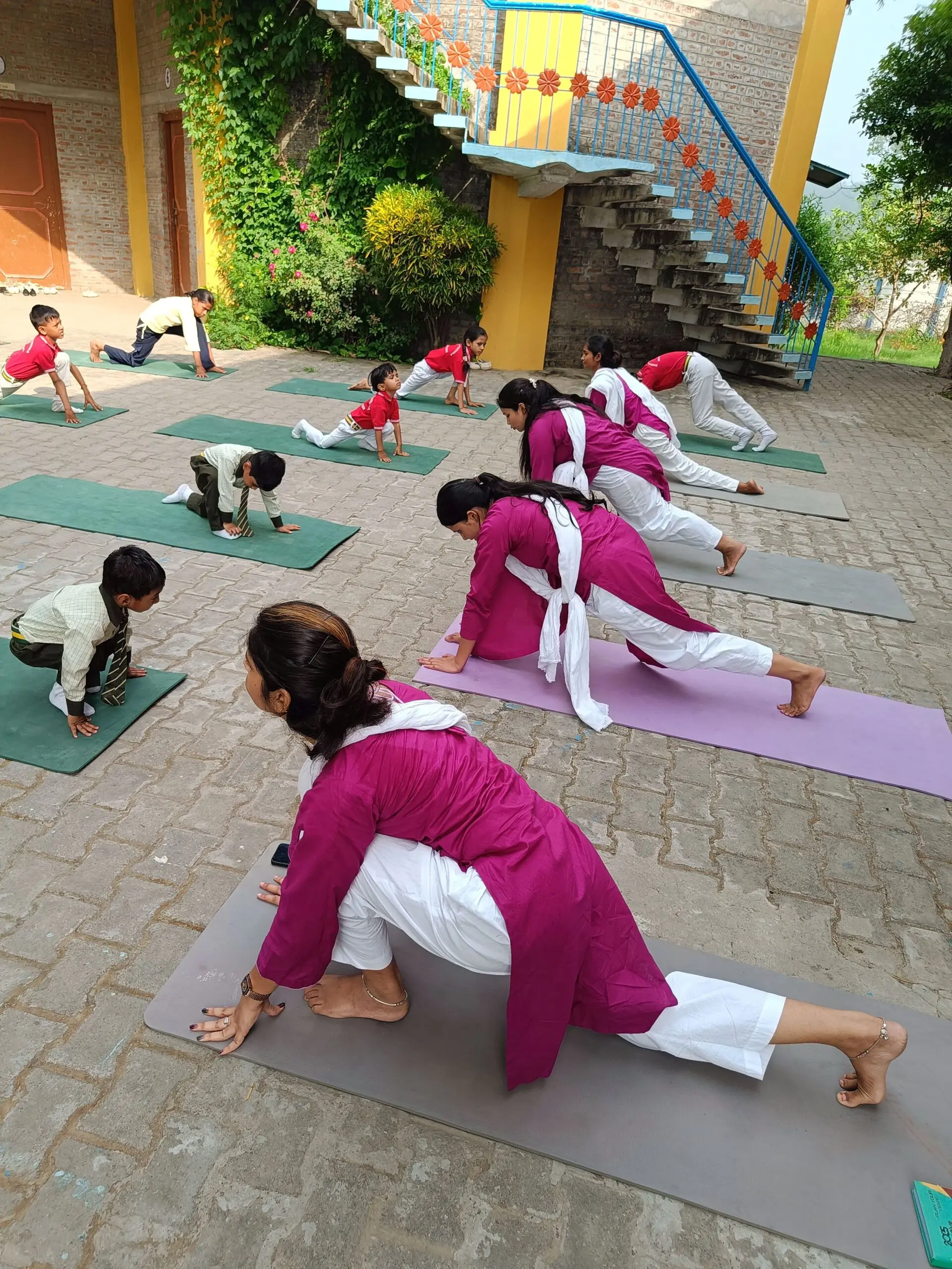 Teachers and students practicing a lunge pose together