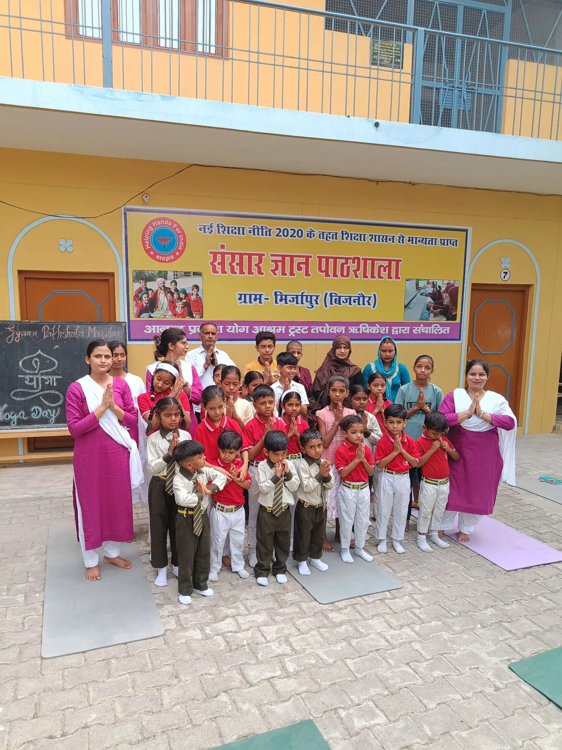 Students, teachers and parents of Sansar Gyaan Pathshala gathered together with hands folded in prayer